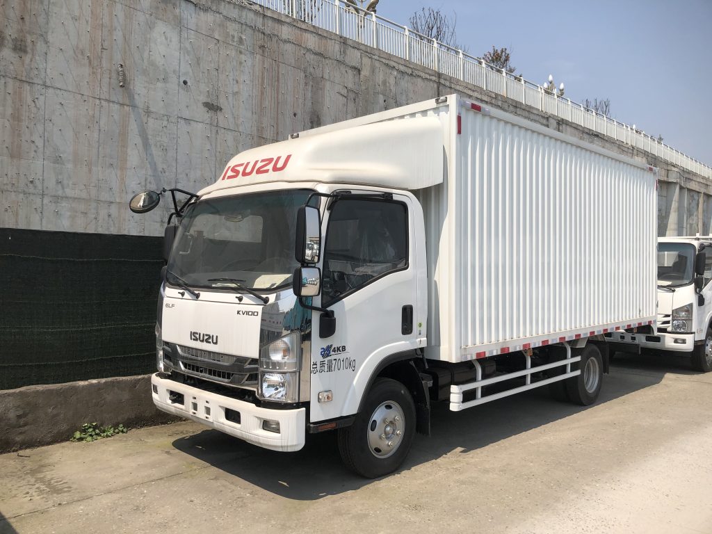 ISUZU KV100 single cab box truck white, commercial enclosed cargo van, 4KB engine, 7010kg GVW, front side view